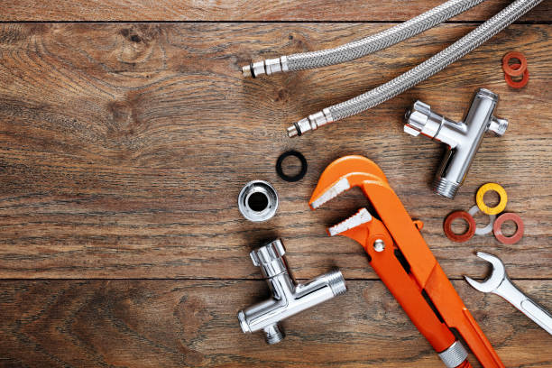 Set of plumbing tools on wooden table background. Set of plumbing tools on wooden table background. Close up top down view with copy space. hose photos stock pictures, royalty-free photos & images