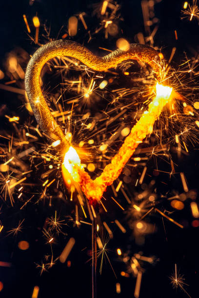 istock Burning Love - heart shaped sparkler 1153465993