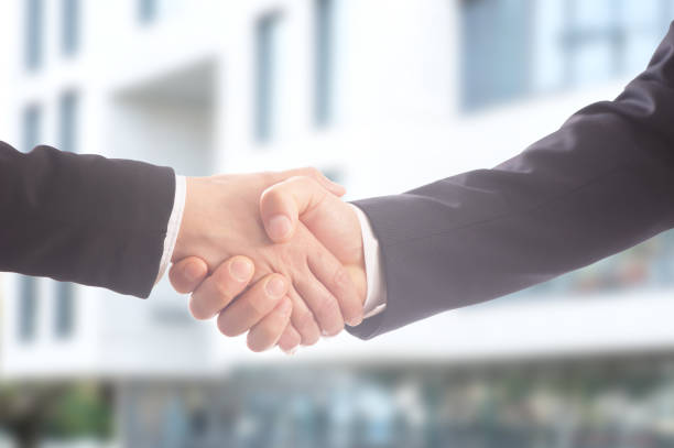 istock Two business people shaking hands 1153466245