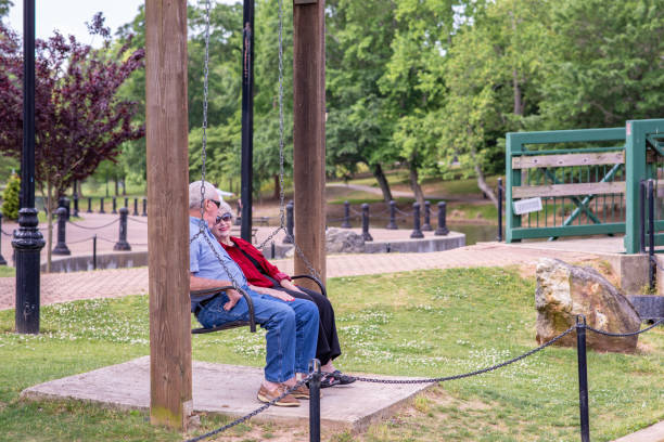 istock Senior couple sitting on a park bench 1153466292