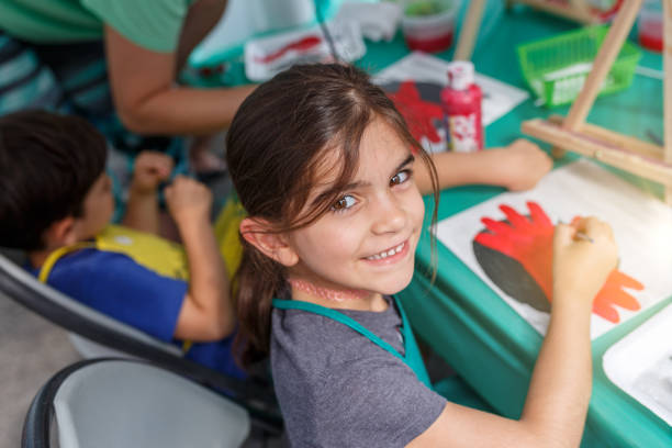 istock Girl learning to paint in community activity 1153468329