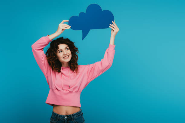 istock happy curly redhead girl holding thought bubble on blue 1153469937