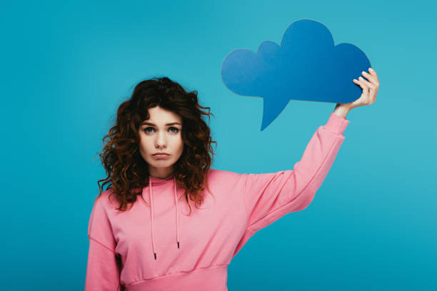 istock upset curly redhead girl holding thought bubble on blue 1153470041