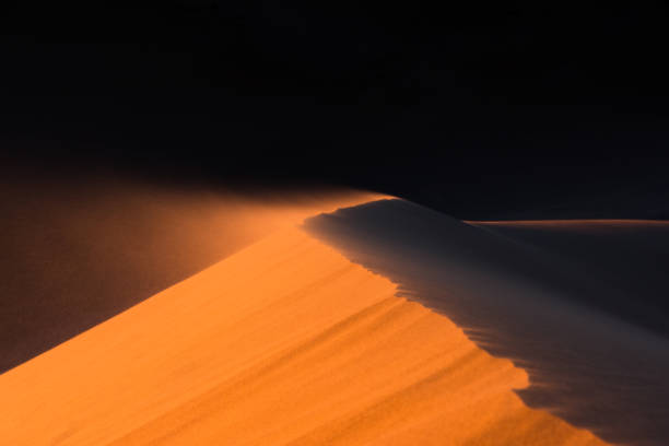 Close up of sand dune moved by the wind , desert of Sahara stock photo