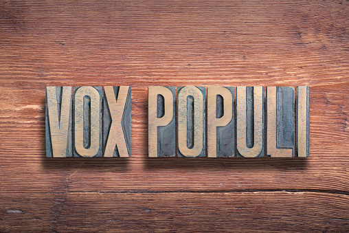 vox populi ancient Latin saying meaning «voice of the people» combined on vintage varnished wooden surface