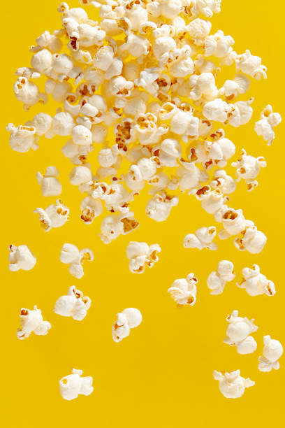 Popcorn On Yellow Background stock photo