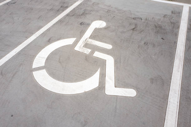 istock Wheel chair symbol on a parking place. 1153474756