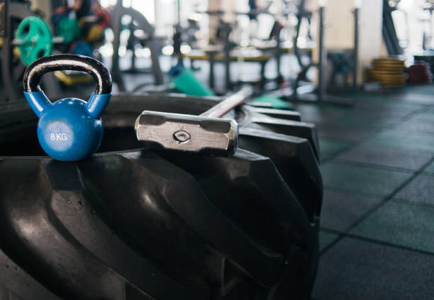 istock Equipment for functional training. Large rubber wheel, hammer, kettlebell closeup in the gym. Cross training 1153476576