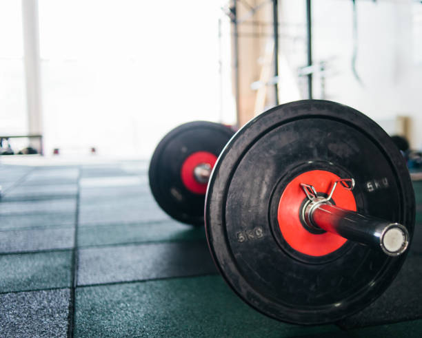 istock Closeup barbell on the gym floor 1153479012