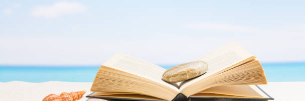 Book on the beach with white sand. Background for banner