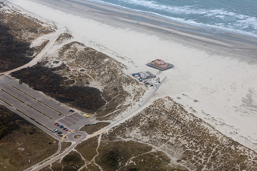 Aerial view construction new beach pavilion at Dutch island Terschelling with large car park