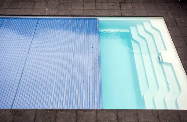 Swimming pool cover detail for protection and heat the water, pool roller-shutter covers Swimming pool cover detail for protection and heat the water, pool roller-shutter covers close-up retractable photos stock pictures, royalty-free photos & images