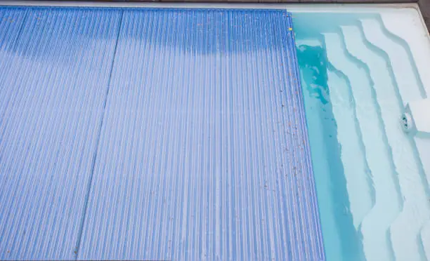 Swimming pool cover detail for protection and heat the water, pool roller-shutter covers close-up