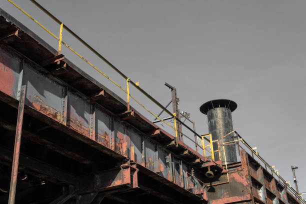 istock View from below of industrial elevated train tracks, smokestack 1153483971