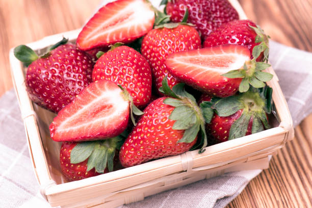 istock Ripe fresh strawberries in plate on a wooden table 1153484519