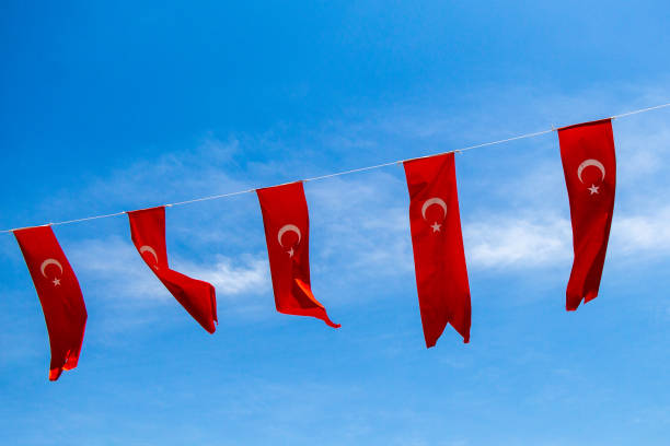 Turkish national flags with white star and moon in sky