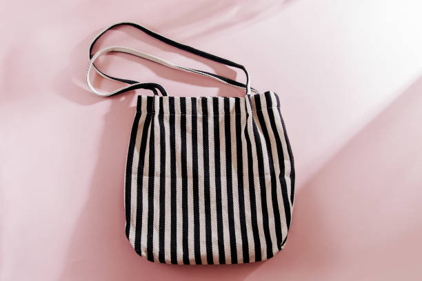 istock Striped cloth shopping bags on pink background. 1153486844