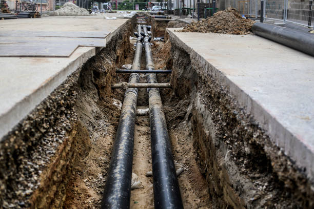 Pipeline Heating and other pipeline in a hole on the street. trench stock pictures, royalty-free photos & images