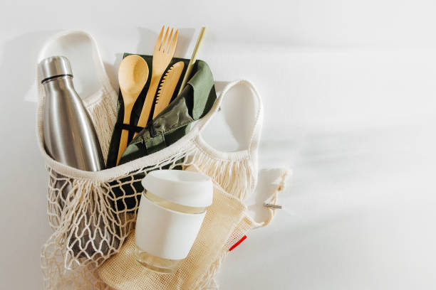 mesh market bag with bamboo cutlery, reusable coffee mug  and  water bottle. sustainable lifestyle.  plastic free concept. - recycled bag imagens e fotografias de stock
