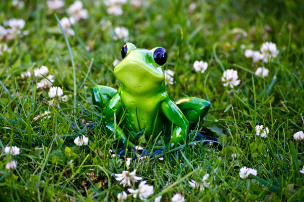 Toy frog sitting in the grass
