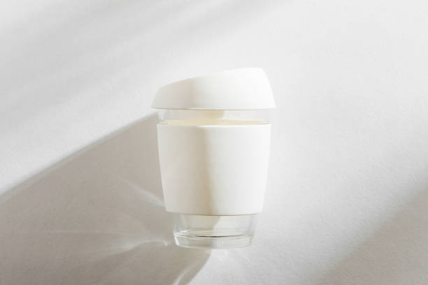 istock White reusable eco coffee cup on white morning background. 1153488260