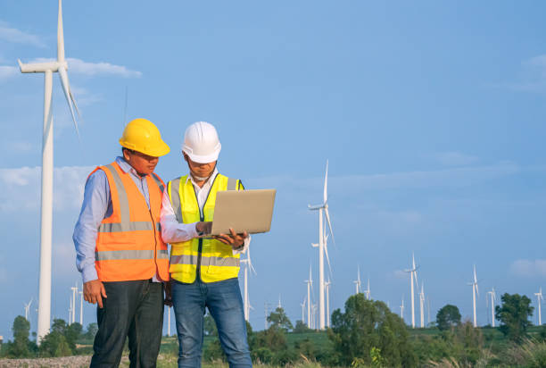 istock Wind Turbine Asian Mechanical Engineer team working by laptop computer at Wind Turbine field,wind power and Alternative energy concept,Electric power industry, 1153488856