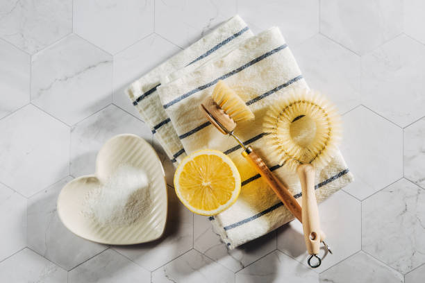 Eco friendly natural cleaning tools and products, bamboo dish brushes and lemon with baking soda. Zero waste concept. Plastic free.