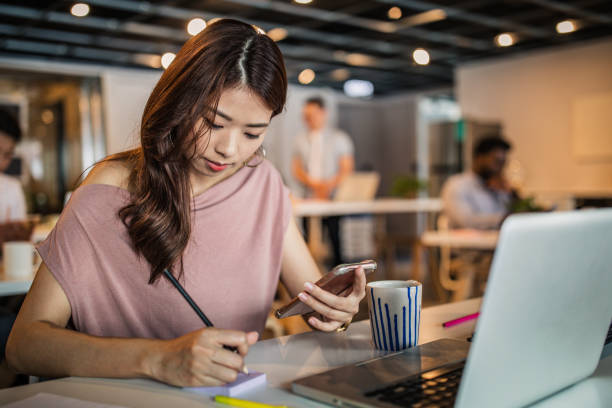istock Beautiful woman working in modern office 1153490128
