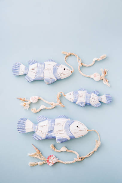 istock Decorative fish  on a  pastel blue background. Sea concept. Nautical pattern. 1153496179