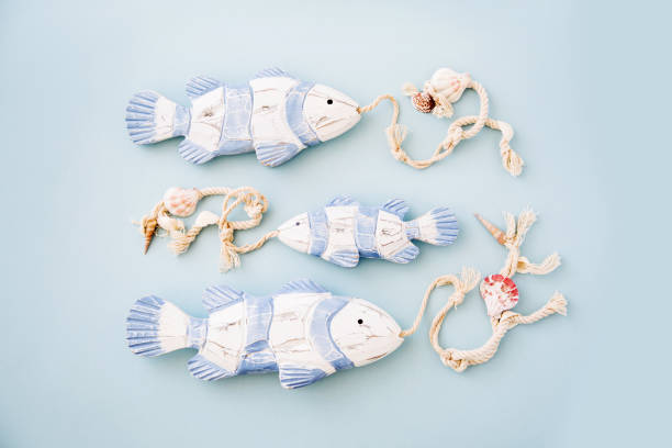 istock Decorative fish  on a  pastel blue background. Sea concept. Nautical pattern. 1153496530