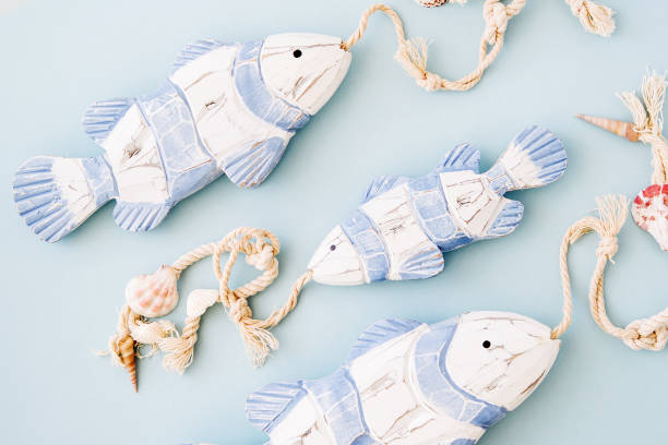 istock Decorative fish  on a  pastel blue background. Sea concept. Nautical pattern. 1153497800