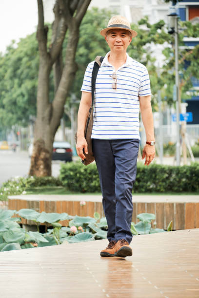 istock Asian senior man walking outdoors 1153498581