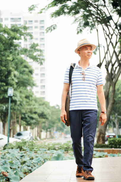 istock Asian man walking in the city 1153498584