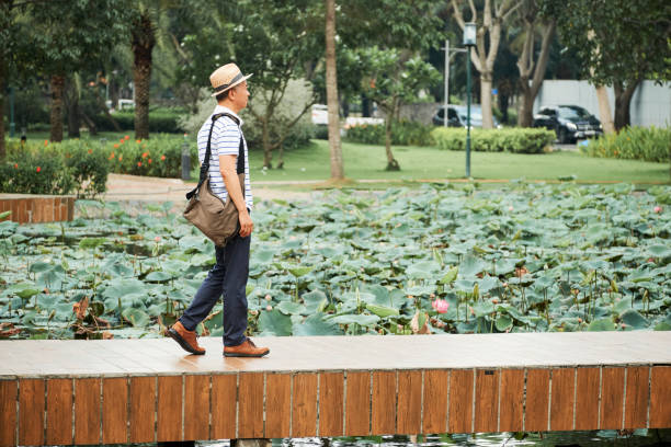 istock Man walking in the park 1153498594