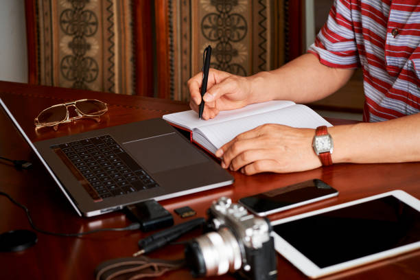 istock Photographer making a list of new orders 1153498644