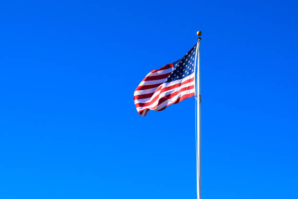 istock USA Flag Waving on a High Quality Clear Blue Sky 1153498733
