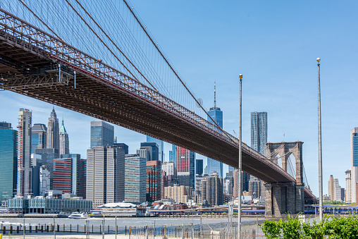 View of the Manhattan Bridge, the coastline and the East River during a sunny springtime day at Brooklyn, New York, USA.