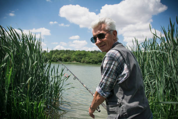 istock Happy senior man on a fishing 1153502881