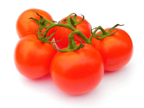 istock Red ripe tomatoes on the green branch. 1153503723