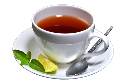 Cup of tea with lemon slice and mint with spoon isolated with white background