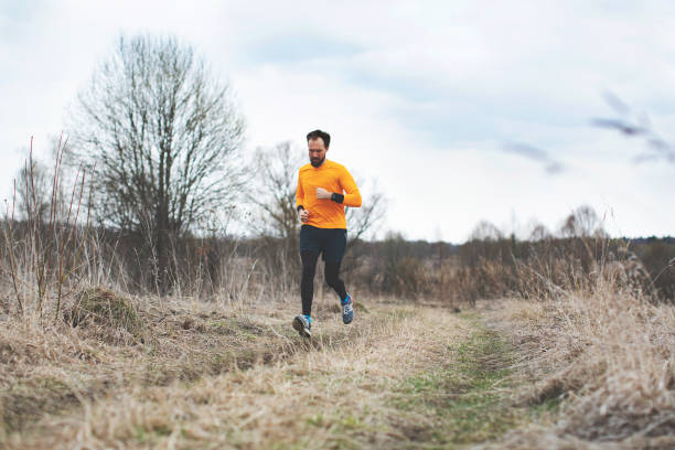 istock Young man running on the field 1153503816