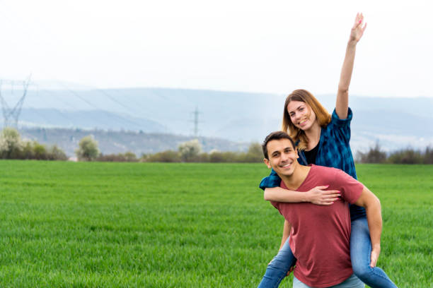 istock Couple walking in field and have fun. 1153505361