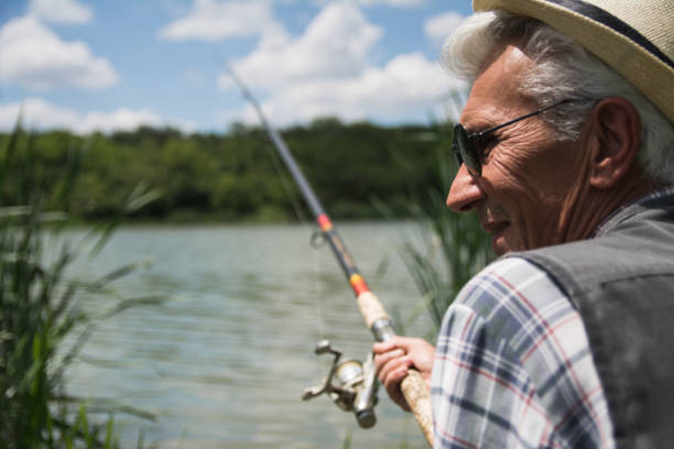 istock Senior man fishing on a lake 1153506471