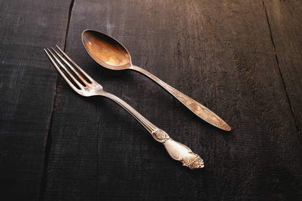 istock vintage fork and spoon. On Wooden background. Top view. 1153512053
