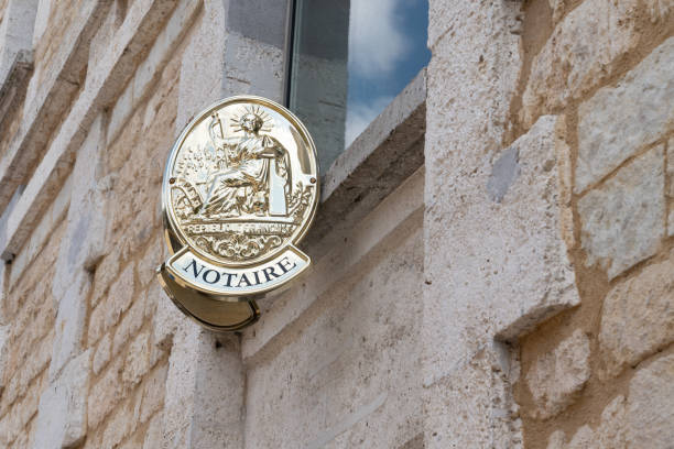 two plate notary in building office for french Notaire French notaire sign on wall above entrance to the notary office witness signature stock pictures, royalty-free photos & images