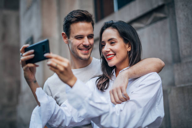 istock Couple standing outdoors and making selfie 1153514305