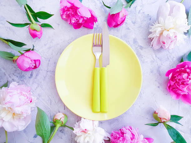 istock peony flower plate on concrete background 1153514771