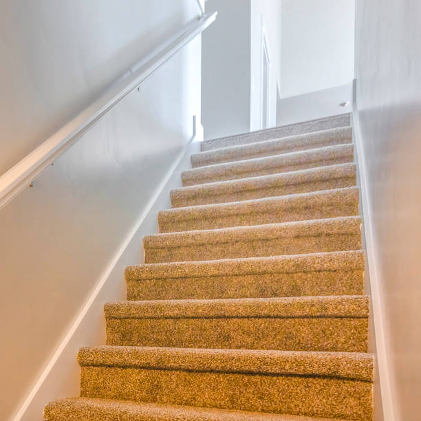 istock Square frame Interior of a house with a staircase covered with brown carpet 1153515797