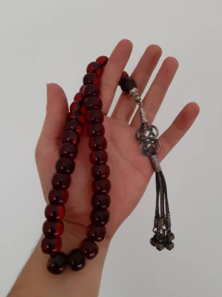 istock Hand holding rosary on white background 1153516185