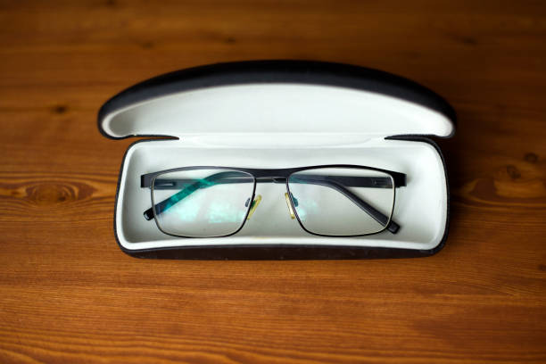 istock spectacles for improving sight in a case on a dark wooden background 1153516199